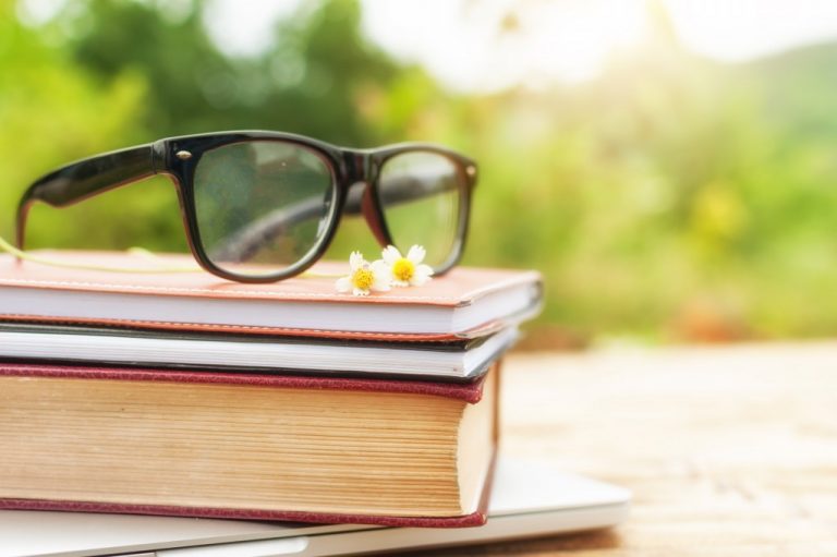 eyeglasses on top of books