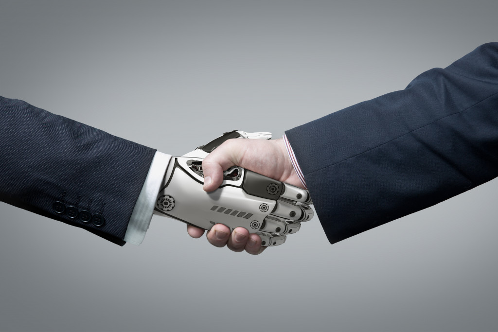 Robot and man shaking hands