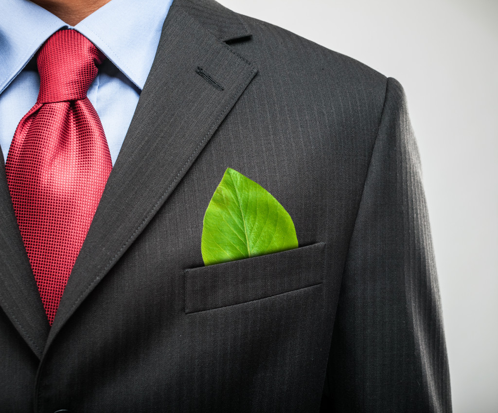 businessman with green leaf on pocket