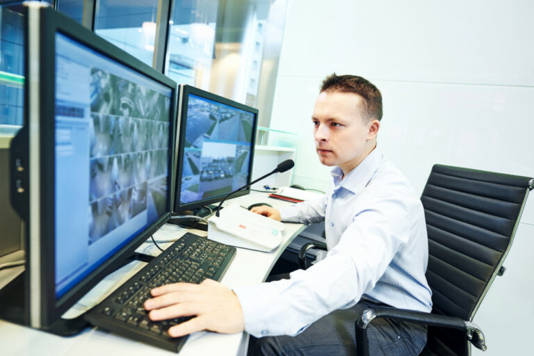 a security guard monitoring CCTV footage